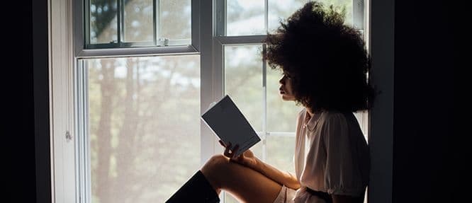 woman reading a domestic thriller book