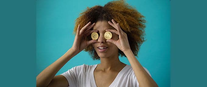 woman holding gold coins over eyes