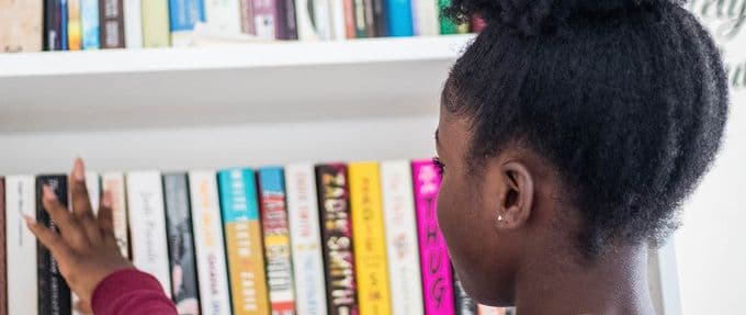 girl looking at bookshelf