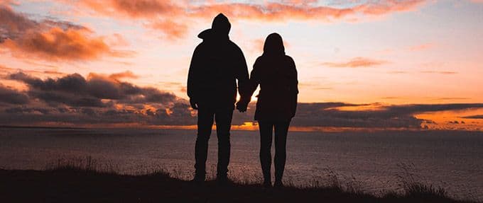 silhouetted romantic couple at sunset
