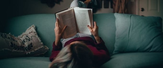 woman reading on couch