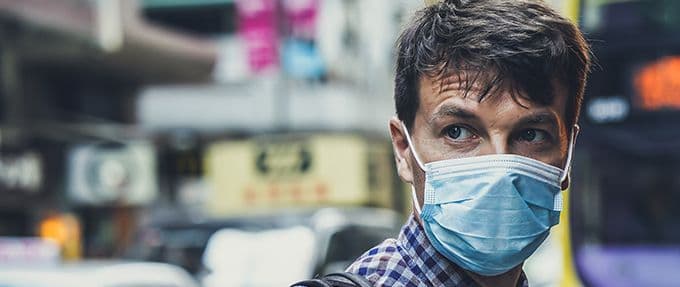 a man wearing a surgical mask to protect from disease