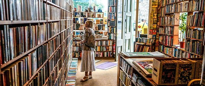 woman looking at books in store