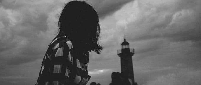 women staring at lighthouse 