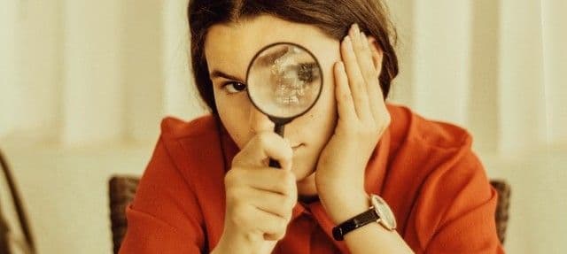 teen girl with a magnifying glass